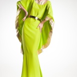 beautiful woman model posing in elegant gold and green dress