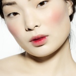Korean model with very pale skin and bloody stain on lips.
