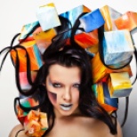 close-up portrait of beautiful young girl with cubes on head.
