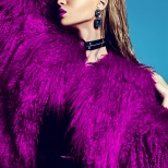 fashion glamor stylish swag young woman model in hipster pink fur coat with bright makeup on blue background